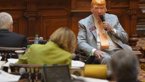 March 24, 2016 Atlanta: Rep. Rusty Kidd wears a Donald Trump mask as he addresses the House during morning orders on the final day of the session Thursday March 24, 2016. BRANT SANDERLIN/BSANDERLIN@AJC.COM