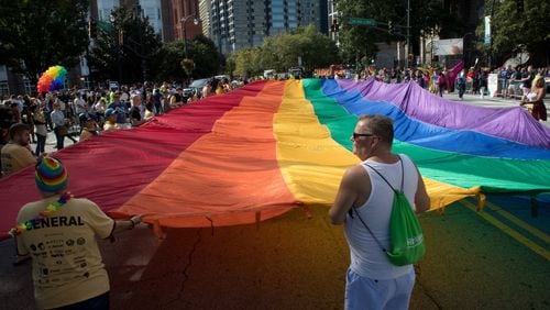 A giant rainbow flag makes its way down Peachtree Street during the Atlanta Pride Parade Sunday in Atlanta October 14, 2018. Photo: STEVE SCHAEFER / SPECIAL TO THE AJC