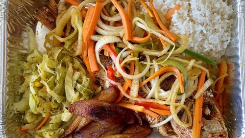Kingston’s Caribbean’s escovitch consists of a fried, whole red snapper topped with spicy pickled vegetables, plus sides of rice, sweet plantains and cabbage. Wendell Brock for The Atlanta Journal-Constitution