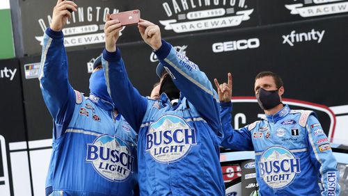 Members of Kevin Harvick's team celebrate after winning the NASCAR Cup Series auto race Sunday in Darlington, S.C.