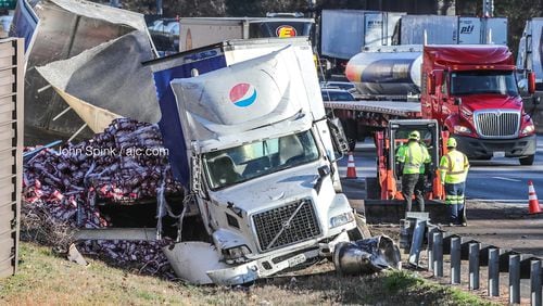 A Pepsi truck hauling cans of Dr Pepper slammed into a barrier wall on I-285 South at Paces Ferry Road early Tuesday morning.