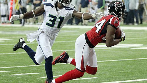011313 ATLANTA : -- RODDY TOUCHDOWN CATCH -- Falcons wide receiver Roddy White catches a touchdown pass in the endzone past Seahawks defender Kam Chancellor for a 20-0 half time lead in their NFL divisional playoff game at the Georgia Dome in Atlanta on Sunday, Jan. 13, 2013. CURTIS COMPTON / CCOMPTON@AJC.COM