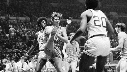 Georgia Tech’s Rich Yunkus (40) grabs a rebound while Michigan’s Ernie Johnson (30) puts on some heat during first-half action of NIT at New York’s Madison Square Garden on Wednesday, March 24, 1971. Georgia Tech’s Jim Thorne (25) is at right. Rich Yunkus burned Michigan with a 27-point, 15-rebound performance to lead Georgia Tech to a 78-70 victory advancing them into the semifinals. (AP Photo/JSJ)