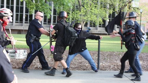 An anti-fascist counter protester clashes with Auburn police before Tuesday’s appearance by white supremacist Richard Spencer. Three people were arrested for disorderly conduct. CHRIS JOYNER / CJOYNER@AJC.COM