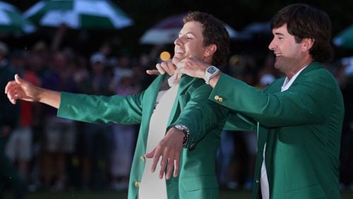 APRIL 14, 2013 AUGUSTA Adam Scott (LEFT), the 2013 Masters champion gets his Green Jacket from the 2012 winner Bubba Watson following Scott's win over Angel Cabrera in a two-hole playoff in the final round of the Masters Tournament at Augusta National Golf Club on Sunday April 14 2013. JASON GETZ / JGETZ@AJC.COM