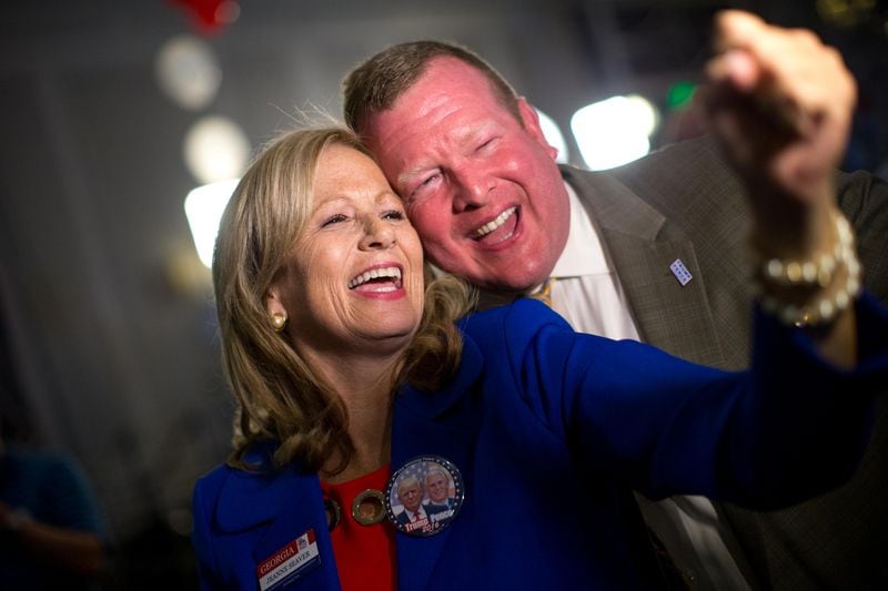 Jeanne Seaver, left, and Brad Carver react after FOX News announced more victories for Republican presidential candidate Donald Trump at the Republican watch party at the Grand Hyatt in Buckhead, Tuesday, Nov. 8, 2016, in Atlanta. (BRANDEN CAMP / SPECIAL)