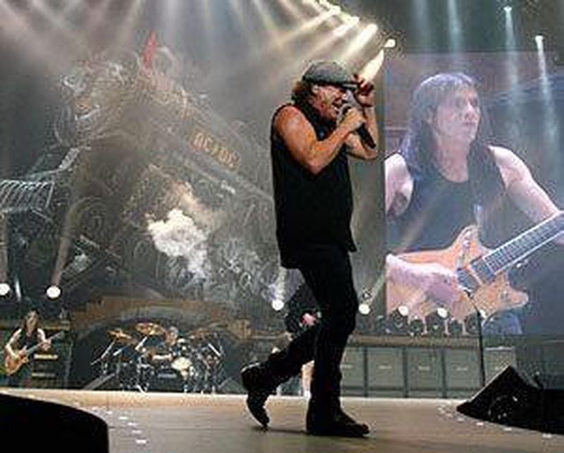  Malcolm Young - in the background, as usual, on the video screen - performing at Philips Arena in 2008. Photo: MIKKI K. HARRIS / mkharris@ajc.com