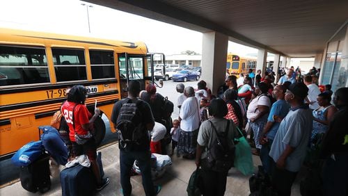 Hundreds of local residents in Brunswick board buses Monday at Lanier Plaza under a mandatory evacuation ahead of Hurricane Dorian for a inland shelter in Columbus.   Curtis Compton/ccompton@ajc.com