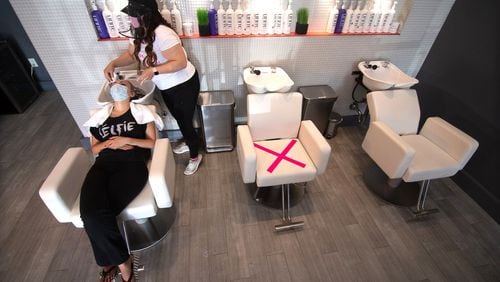Blo Blow Dry Bar district manager Maria Dowling works on Sara Askari’s hair at the Buckhead location Thursday, July 2, 2020. STEVE SCHAEFER FOR THE ATLANTA JOURNAL-CONSTITUTION