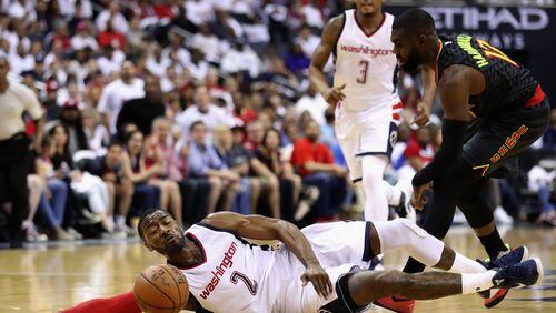 WASHINGTON, DC - APRIL 16: John Wall #2 of the Washington Wizards and Tim Hardaway Jr. #10 of the Atlanta Hawks go after a loose ball in the first half of Game One of the Eastern Conference Quarterfinals during the 2017 NBA Playoffs at Verizon Center on April 16, 2017 in Washington, DC. NOTE TO USER: User expressly acknowledges and agrees that, by downloading and or using this photograph, User is consenting to the terms and conditions of the Getty Images License Agreement. (Photo by Rob Carr/Getty Images)