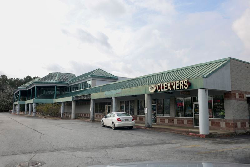 The cleaners is the only store open at the Lake City Crossing shopping center on Jonesboro Rd., Thursday, Feb. 23, 2023, in Morrow, Ga.. No work has been done on this site to build an amphitheater and 27-story condo building by summer 2023. Jason Getz / Jason.Getz@ajc.com)
