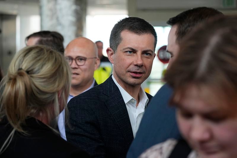 U.S. Transportation Secretary Pete Buttigieg, center, greets well-wishers after a news conference to announce a new partnership that will streamline how consumer complaints against airlines are resolved in the terminal at Denver International Airport Tuesday, April 16, 2024, in Denver. (AP Photo/David Zalubowski)