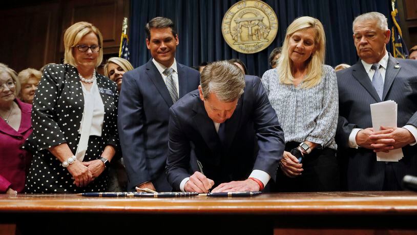 Surrounded by supporters of the bill, including Sen. Renee Unterman (from left), R - Buford, Lt. Gov. Geoff Duncan, First Lady Marty Kemp, and House Speaker David Ralston, Gov. Brian Kemp signed HB 481, the "heartbeat bill", on Tuesday, setting the stage for a legal battle as the state attempts to outlaw most abortions after about six weeks of pregnancy. The bill, sponsored by Rep. Ed Setlzer, R-Acworth, and carried in the Senate by Sen. Renee Unterman, R - Buford, outlaws most abortions once a doctor can detect a fetus' heartbeat - usually around six weeks of pregnancy. Bob Andres, bandres@ajc.com