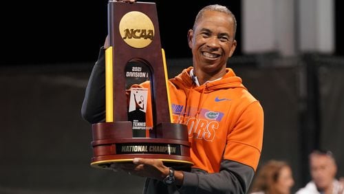 Florida men's tennis coach Bryan Shelton poses with the NCAA championship trophy after leading the Gators to a 4-1 win over Baylor in the title match May 22, 2021 in Orlando, Fla. Shelton, a Georgia Tech grad, became the first coach to lead men's and women's tennis teams to NCAA national championships.
(Manuela Davies/USTA)