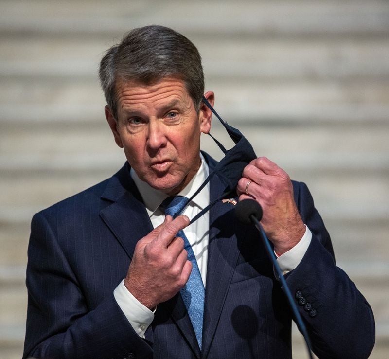 Governor Brian P. Kemp takes off his mask before speaking at a press conference at the state capital on Tuesday, Nov. 8, 2020.   STEVE SCHAEFER FOR THE ATLANTA JOURNAL-CONSTITUTION