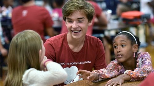Nathan Jones, 17, interacts with elementary students at Compton Elementary School in Powder Springs on Sept. 20. HYOSUB SHIN / HSHIN@AJC.COM