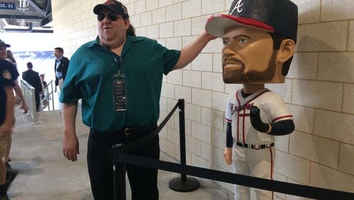 Joey Stuckey "meets" one of his favorite Braves players ever, Hall of Fame pitcher John Smoltz. The giant bobblehead is one of 10 found around SunTrust Park during the Braves inaugural season. Photo by Jill Vejnoska/jvejnoska@ajc.com