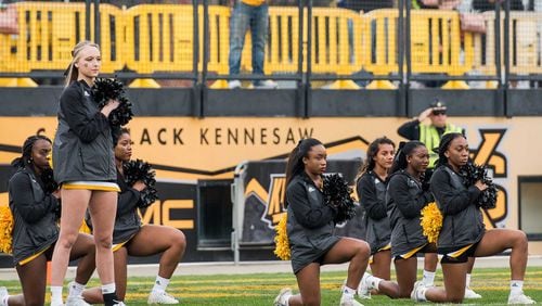File Photo: Kennesaw State cheerleaders take a knee during a 2017 football game. Photo: Cory Hancock/Special to the AJC