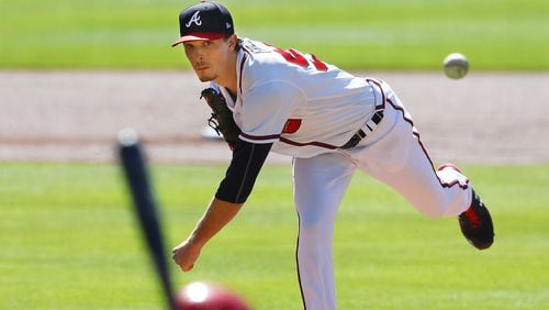 Braves starting pitcher Max Fried delivers against the Cincinnati Reds during the first inning of Game 1 of the National League wild card playoff series Wednesday at Truist Park. (Curtis Compton / Curtis.Compton@ajc.com)