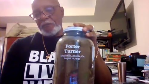 Leland Scott Jr. shows off a jar used to collect soil from the Druid Hills address where Porter Turner was found dead on Aug. 21, 1945. Members of the Ku Klux Klan are suspected of stabbing Turner to death, making him DeKalb County's last known lynching victim. Screenshot taken during the family Zoom call to honor the 75th anniversary or Turner's death.