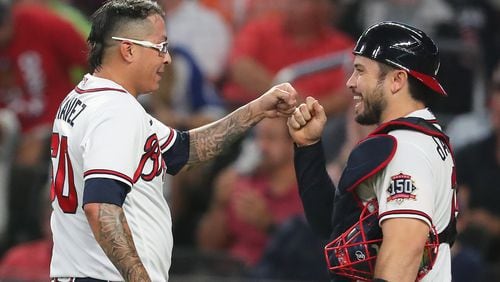 Braves catcher Travis d'Arnaud gives reliever Jesse Chavez a fist pump after he came in to shut down the Reds on Aug. 11, 2021, in Atlanta.   (Curtis Compton / Curtis.Compton@ajc.com)
