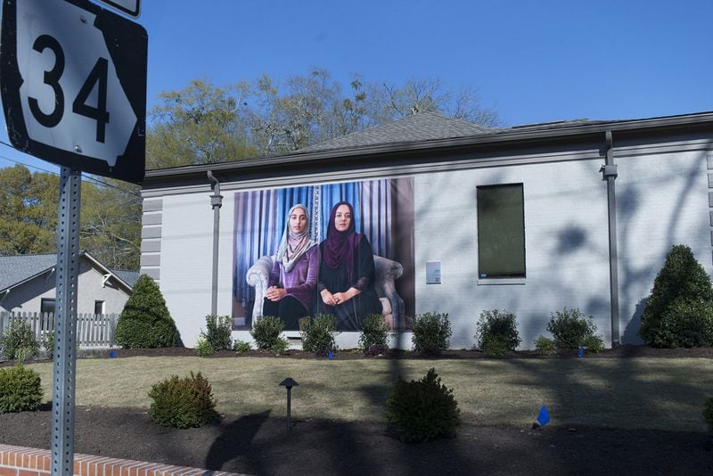 Sisters Aatika and Zahraw Shah are Newnan residents featured on large-scale photo banners in the city’s downtown. Contributed by Mary Beth Meehan