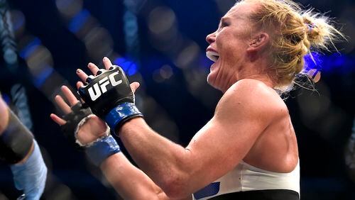 Holly Holm celebrates after defeating Ronda Rousey during thier UFC 193 Bantamweight title fight in Melbourne, Australia, Sunday, Nov. 15, 2015. (AP Andy Brownbill)