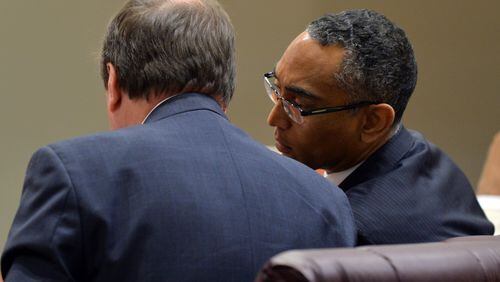 Suspended DeKalb County CEO Burrell Ellis talks to attorney Craig Gillen in the DeKalb County courtroom where jurors are deciding his fate. Ellis is fighting charges that he intimidated companies doing business with DeKalb into giving him campaign contributions. BRANT SANDERLIN / BSANDERLIN@AJC.COM