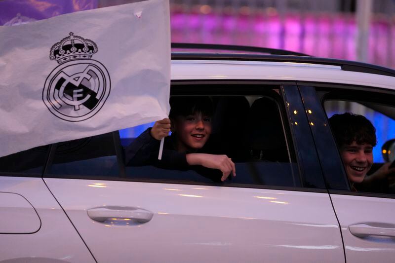 Real Madrid supporters celebrate in Cibeles Square in Madrid after their team clinched the La Liga title, Saturday, May 4, 2024. Real, who had won earlier in the day, clinched the title after Barcelona failed to beat Girona. (AP Photo/Manu Fernandez)