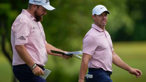 Rory McIlroy, right, of Northern Ireland, and teammate Shane Lowry, of Ireland, walk down the first fairway during the first round of the PGA Zurich Classic golf tournament at TPC Louisiana in Avondale, La., Thursday, April 25, 2024. (AP Photo/Gerald Herbert)