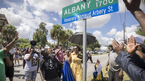 BRUNSWICK, GA - AUGUST, 9, 2022: Ahmaud Arbery's father, Marcus Arbery, and his mother Wanda Cooper-Jones, look on as city officials unveil a street sign commemorating their slain son. (AJC Photo/Stephen B. Morton)