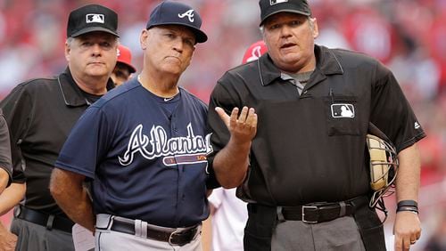 Home plate umpire Hunter Wendelstedt points out the eccentricities of Busch Stadium to Braves interim manager Brian Snitker prior to the Braves' baseball game against the St. Louis Cardinals, Friday, Aug. 5, 2016, in St. Louis.
