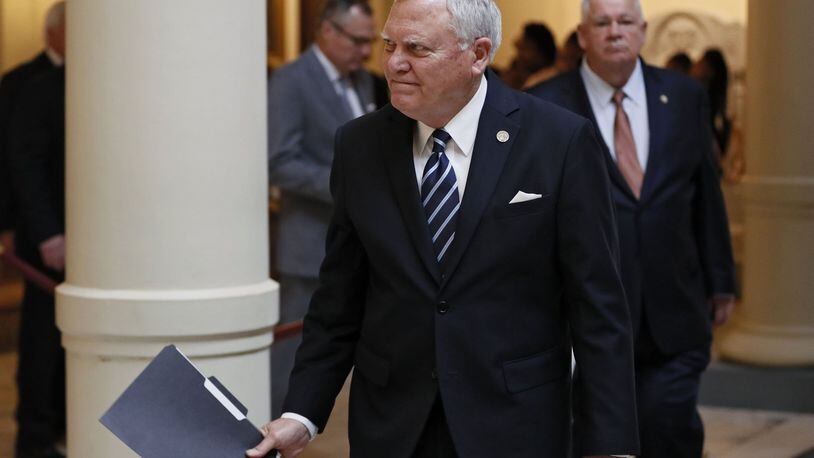 Gov. Nathan Deal, followed by House Speaker David Ralston, heads to a press conference on Feb. 20. Deal’s new state budget closes a $167 million gap between the amount schools get and the amount they’re supposed to get under the Quality Basic Education formula. BOB ANDRES /BANDRES@AJC.COM