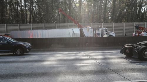 All northbound lanes of I-285 were shut down past Hollowell Parkway while authorities worked to upright a tractor-trailer that overturned on the interstate Tuesday morning.