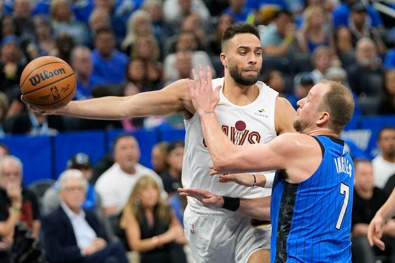 Cleveland Cavaliers guard Max Strus, left, passes the ball around Orlando Magic guard Joe Ingles (7) during the first half of Game 6 of an NBA basketball first-round playoff series, Friday, May 3, 2024, in Orlando, Fla. (AP Photo/John Raoux)