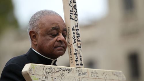 March 25, 2016 Atlanta - Archbishop Wilton D. Gregory 
closes his eyes in prayer at the second station of the cross at Talmadge Park. Attendants commemorated the stations of the cross along the pilgrimage and reflected on issues at every station. TAYLOR CARPENTER / TAYLOR.CARPENTER@AJC.COM
