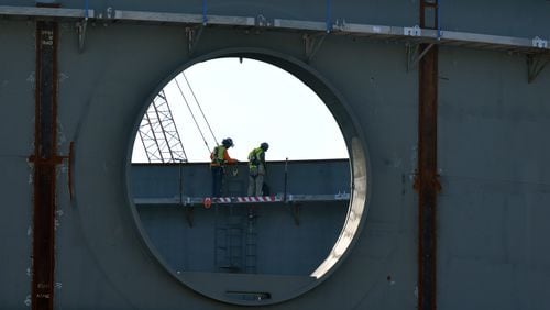 In this 2015 photo, workers inside the partly constructed containment structure on of one of the two new nuclear power plants being built at Plant Vogtle. AJC/file