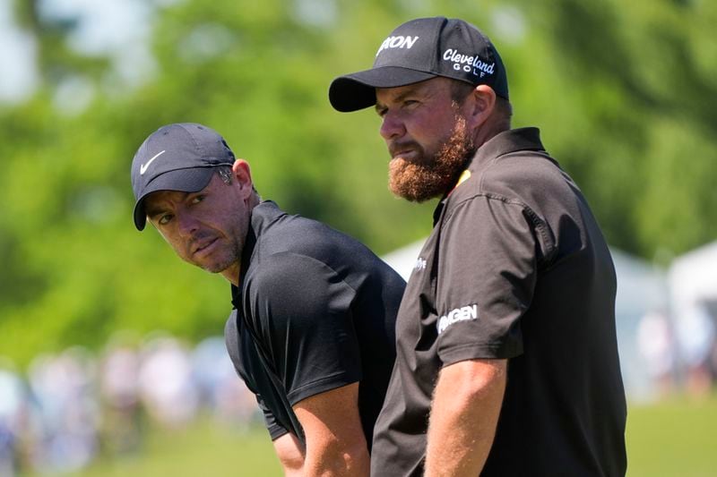 Rory McIlroy, of Northern Ireland, waits his torun on the 18th green with his teammate Shane Lowry, of Ireland, right, during the second round of the PGA Zurich Classic golf tournament at TPC Louisiana in Avondale, La., Friday, April 26, 2024. (AP Photo/Gerald Herbert)