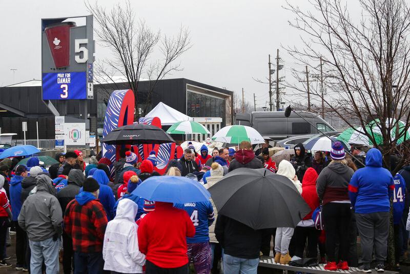 Bills fans and community members gather outside Highmark Stadium for a prayer circle for Buffalo Bill' Damar Hamlin on Tuesday, Jan. 3, 2023, in Orchard Park, N.Y. The family of Damar Hamlin expressed gratitude for the outpouring of support shown toward the Buffalo Bills safety who suffered cardiac arrest after making a tackle while asking everyone to keep the hospitalized player in their prayers on Tuesday. (AP Photo/Joshua Bessex)
