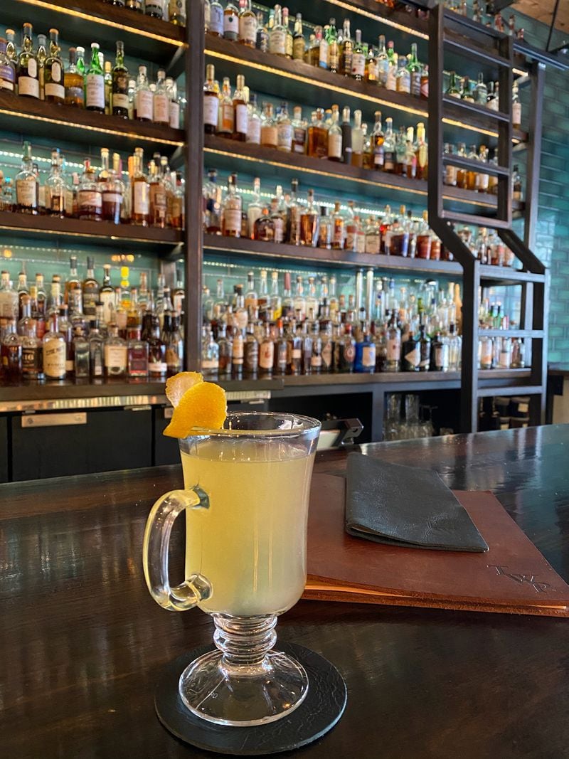 Behind this Naughty Toddy can be seen the Whiskey Project's wall of more than 1,000 spirit choices. Courtesy of Arianne Fielder