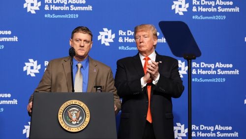 With President Donald Trump looking on, Virginia state police Senior Special Agent Ervin Thomas Murphy speaks about the death of his son from opioids during the Rx Drug Abuse & Heroin Summit on in Atlanta on Wednesday. Jessica McGowan/Getty Images