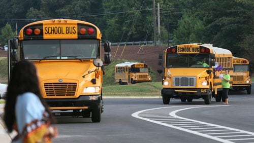 Aug. 10, 2015 - Lawrenceville - Busses arrive on the first day back at school at Baguette Elementary School in Lawrenceville. Metro Atlanta area teachers and students headed back to school on Monday. It was the first day of school in Fulton, Gwinnett and DeKalb counties. Brand new Baggett Elementary School opened in Lawrenceville with a 1,125 student capacity. BOB ANDRES / BANDRES@AJC.COM