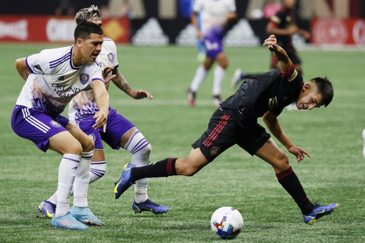 Atlanta United's Thiago Almada battles for the ball against Orlando defenders during the second half of an MLS game Sunday at Mercedes-Benz Stadium. (Miguel Martinez /Miguel.martinezjimenez@ajc.com)