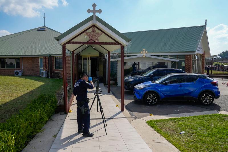 A police forensic officer works at a crime scene at the Christ the Good Shepherd church in suburban Wakely in western Sydney, Australia, Tuesday, April 16, 2024. Australian police say a knife attack in Sydney that wounded a bishop and a priest during a church service as horrified worshippers watched online and in person, and sparked a riot was an act of terrorism. (AP Photo/Mark Baker)