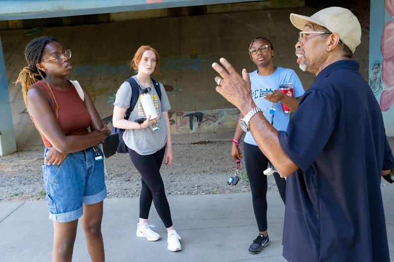 Georgia Tech students Zarya Ajasin, from left, and Meg Sanders, along with Spelman student Sommer Madison listen to Darryl Haddock, director of environmental education for the West Atlanta Watershed Alliance, as they mapped temperatures along the Westside Beltline on Wednesday, June 15, 2022, for a research study. (Ben Gray for the Atlanta Journal-Constitution)