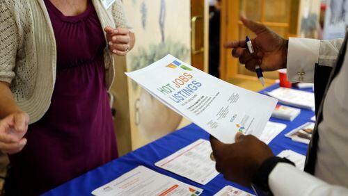 In this 2015 file photo, employment opportunities are discussed at a job fair for veterans, in Pembroke Pines, Florida.
