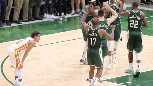 062321 Milwaukee: Atlanta Hawks guard Trae Young looks on as Milwaukee Bucks forward Giannis Antetokounmpo gets five from teammate after scoring and drawing a foul to take a 102-98 lead over the Hawks with 4:31 left to play in game 1 of the NBA Eastern Conference Finals on Wednesday, June 23, 2021, in Milwaukee. The young and relentless Hawks rallied in the final minutes for a 116-113 victory over the Bucks.  “Curtis Compton / Curtis.Compton@ajc.com”