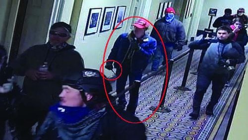 The FBI's criminal complaint against Bruno Cua, 18, of Milton, includes images from U.S. Capitol security cameras that show him carrying what appears to be a baton.