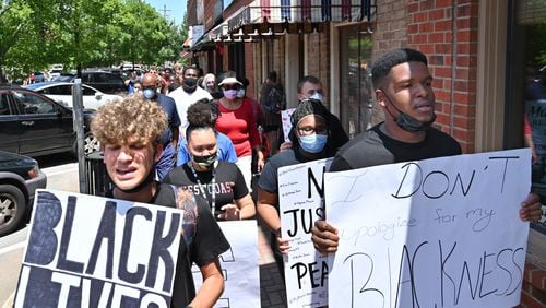 John Kirbymurdoch. left, and Alex Williams, both 16 and students at Morgan County High School, lead a peaceful, youth-led march in downtown Madison in June. (Hyosub Shin / Hyosub.Shin@ajc.com)