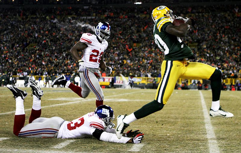 Packers wide receiver Donald Driver dashes away from New York Giants defenders Corey Webster (bottom) and Gibril Wilson for a touchdown.